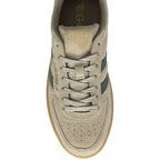 A top-down view of a single Gola low-top sneaker in beige suede with green stripes.