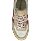 Close up of a Gola sneaker with a beige suede and white leather upper, red stripes, and white laces