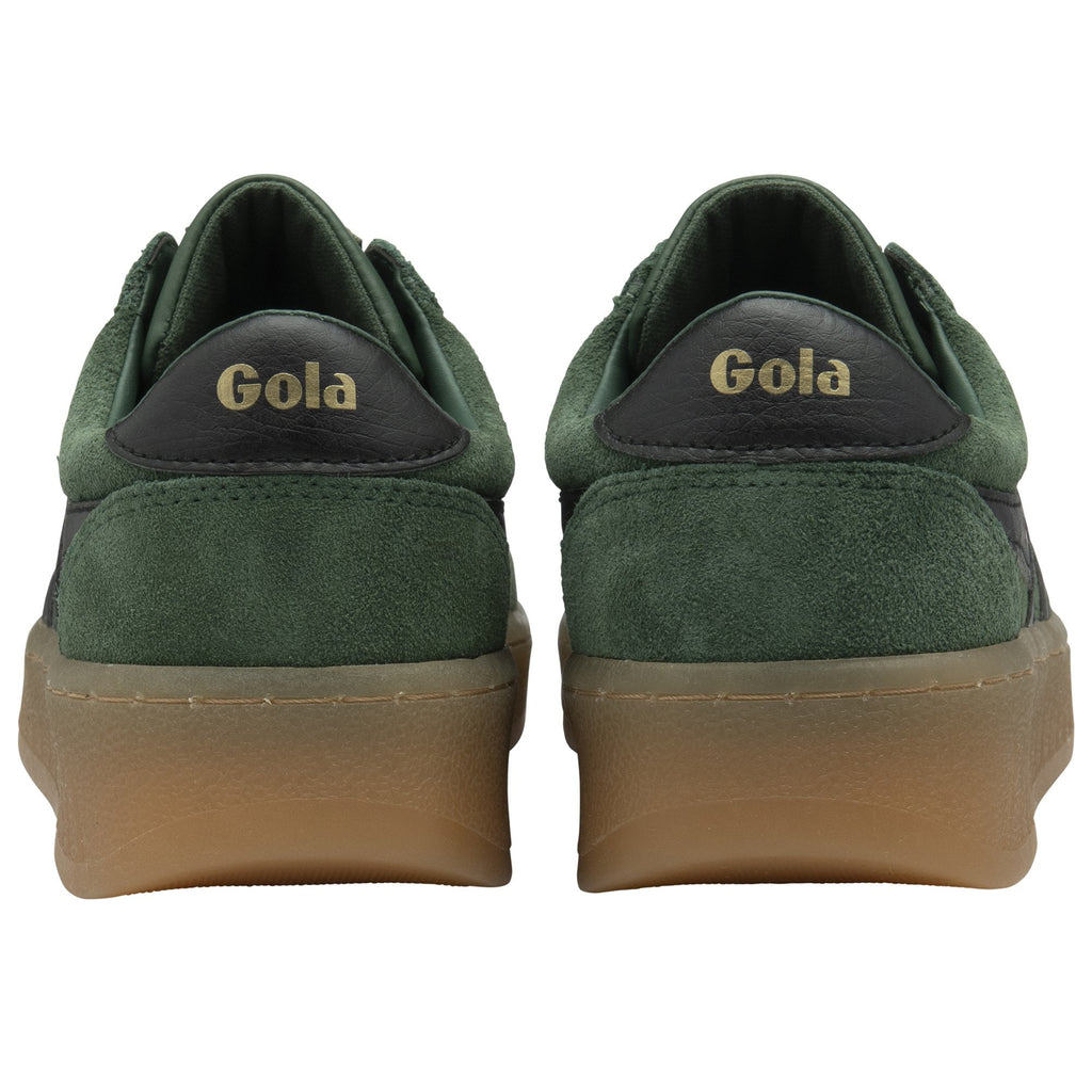 The back of a pair of dark green Gola sneakers, showing the Gola logo on the heels.