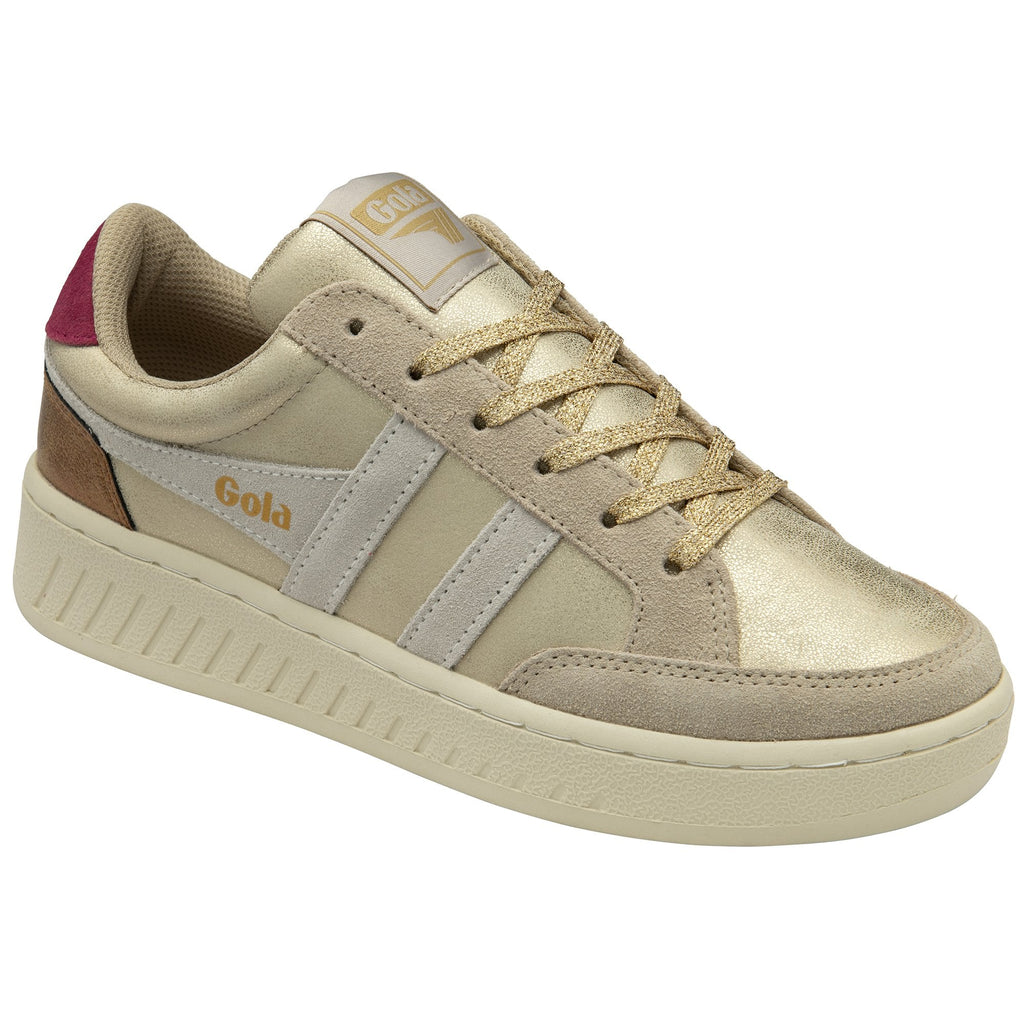Angled view of a gold metallic and beige Gola sneaker with a red heel detail.