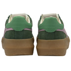 Back view of a pair of green and pink sneakers with thick brown soles.