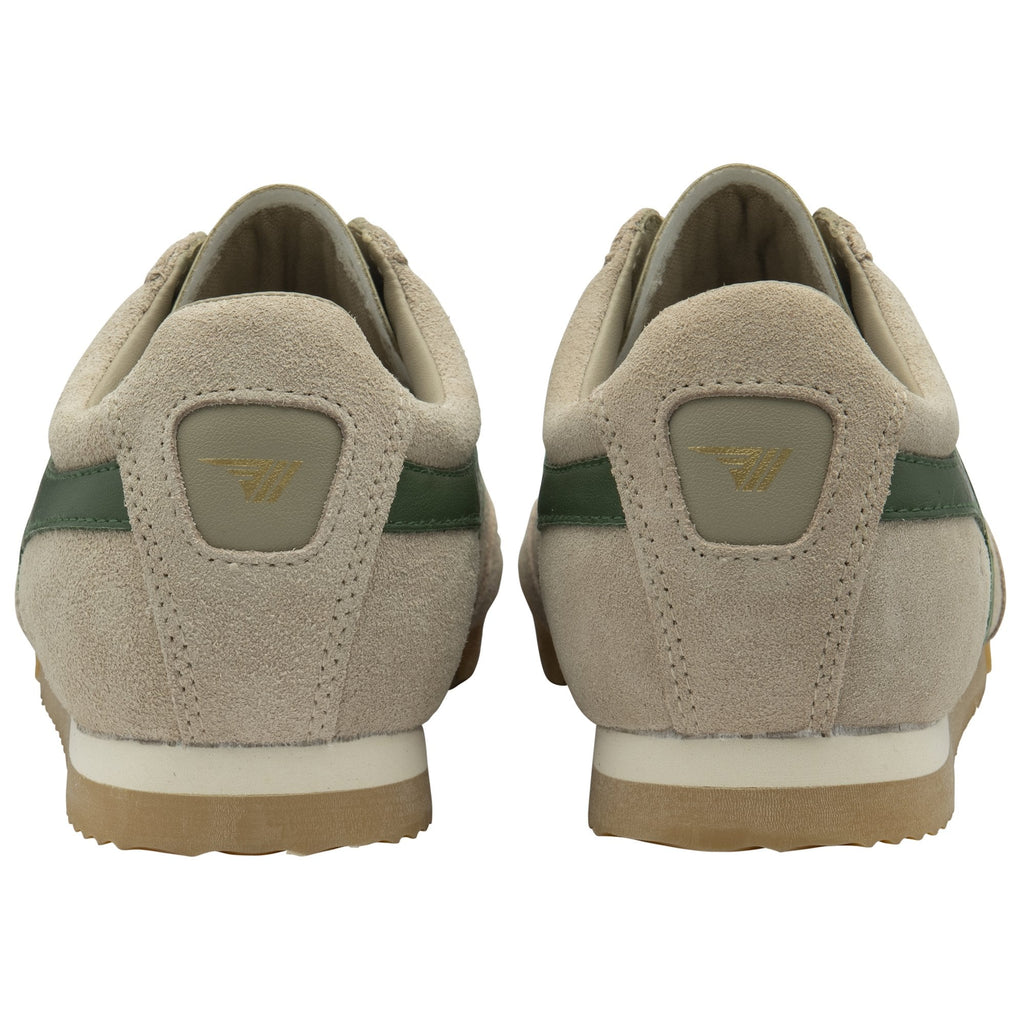 The back view of a pair of Gola Harrier trainers in tan with green stripes.