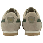 The back view of a pair of Gola Harrier trainers in tan with green stripes.