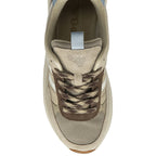 An overhead view of a single beige, brown, and light blue sneaker with patterned laces.