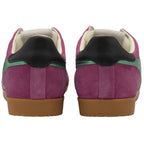 A back view of pink Gola sneakers with green stripes and black heels.