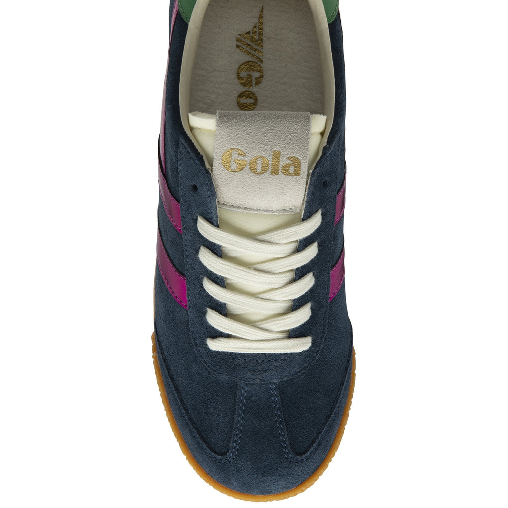 An overhead view of a single dark blue suede Gola low-top sneaker, with fuchsia stripes.