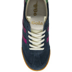 An overhead view of a single dark blue suede Gola low-top sneaker, with fuchsia stripes.