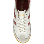 Top down view of a white Gola sneaker with red stripes and white laces.