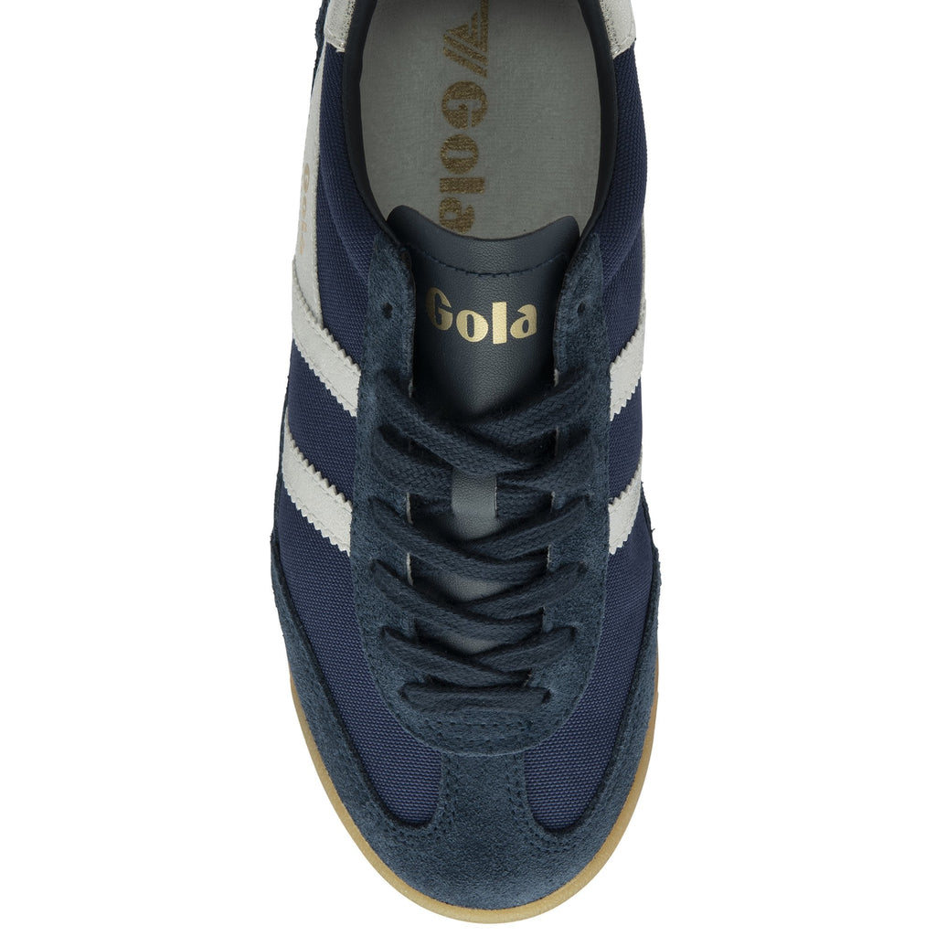 The top-down view of a single Gola Harrier trainer in navy with white stripes and a gum sole.
