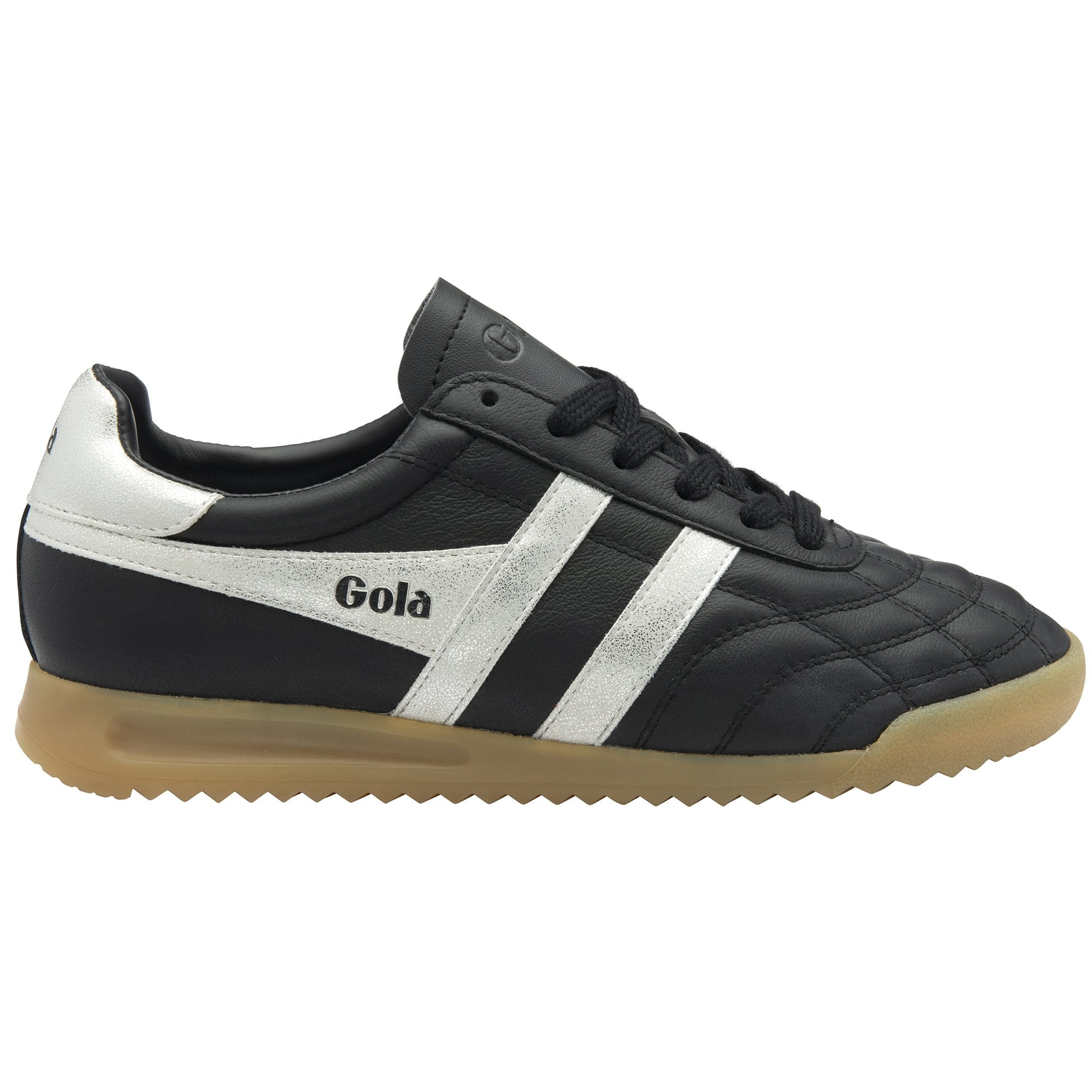 A single Gola low-top indoor soccer shoe in black and white with a gum sole, right side view.