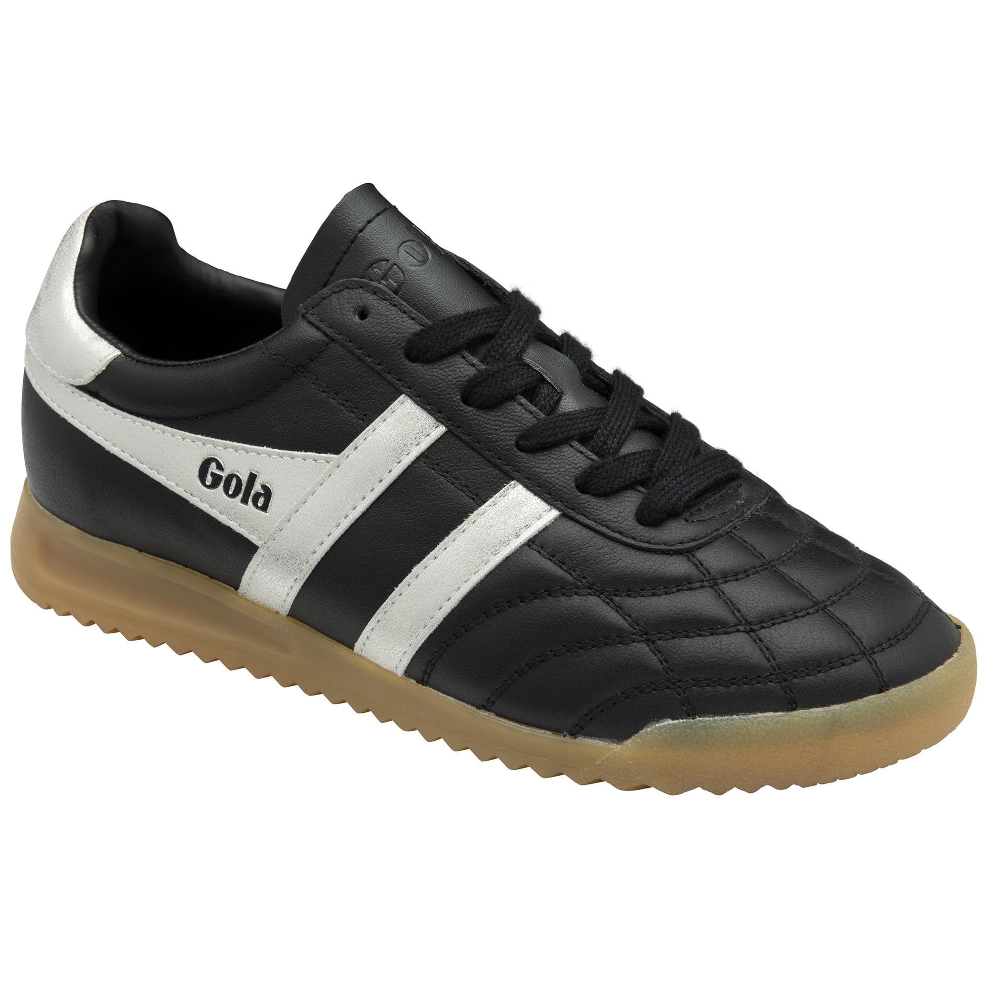 A single Gola low-top indoor soccer shoe in black and white with a gum sole, left side view.