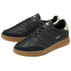 A pair of black Gola sneakers with gold accents and gum soles, positioned at an angle.