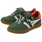 A pair of dark green suede sneakers with white stripes, patterned laces, and red heels.