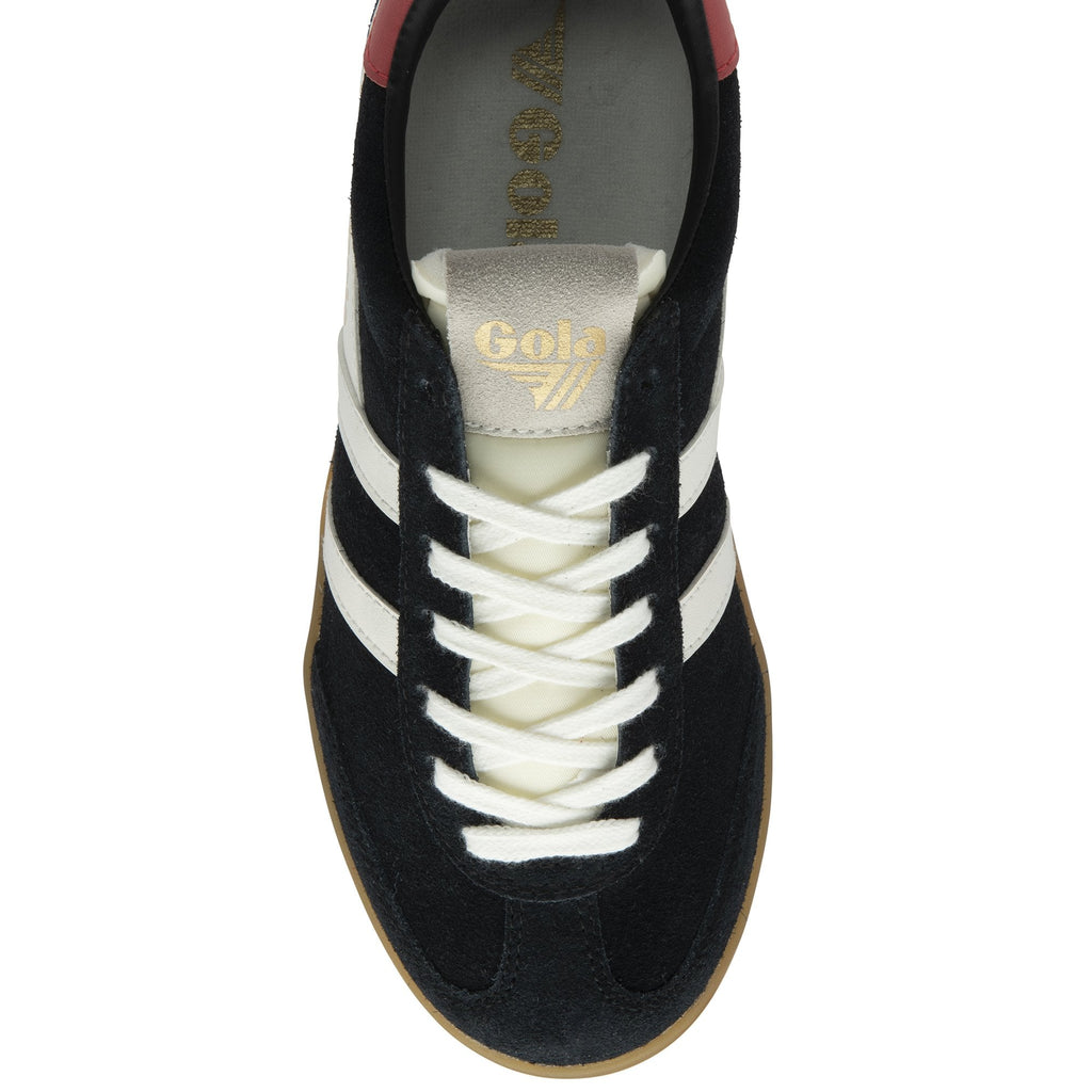 The top-down view of a black sneaker with white stripes, cream laces, and a red heel.