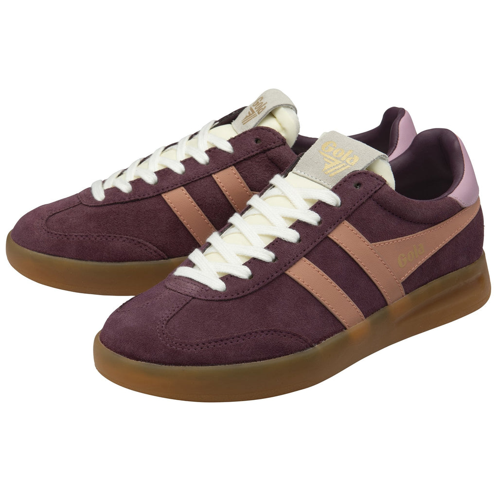 A pair of Gola low-top sneakers in burgundy suede with two pink stripes and gum soles.