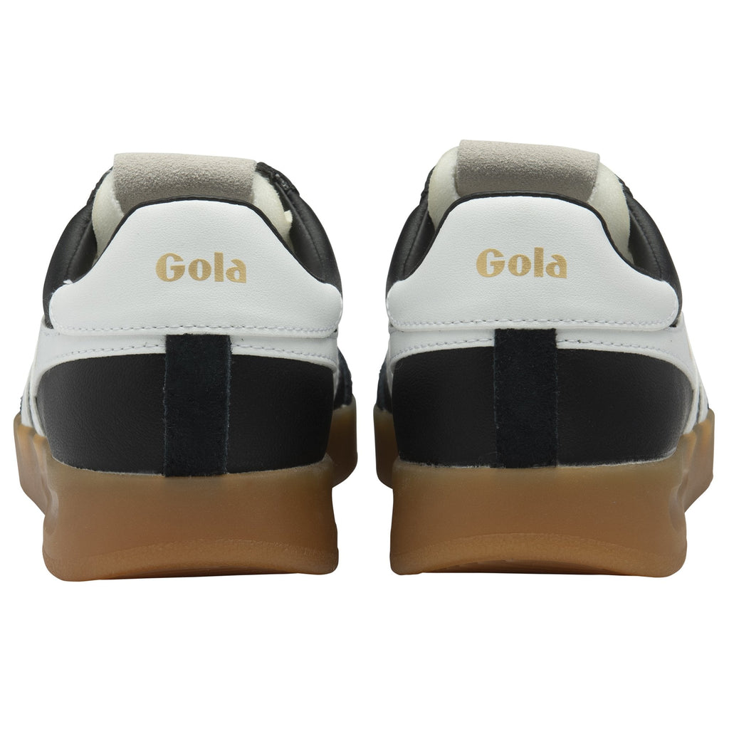 Back view of a pair of black and white Gola low-top sneakers with gum soles.