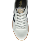 The top-down view of a white and navy sneaker with a gum sole.