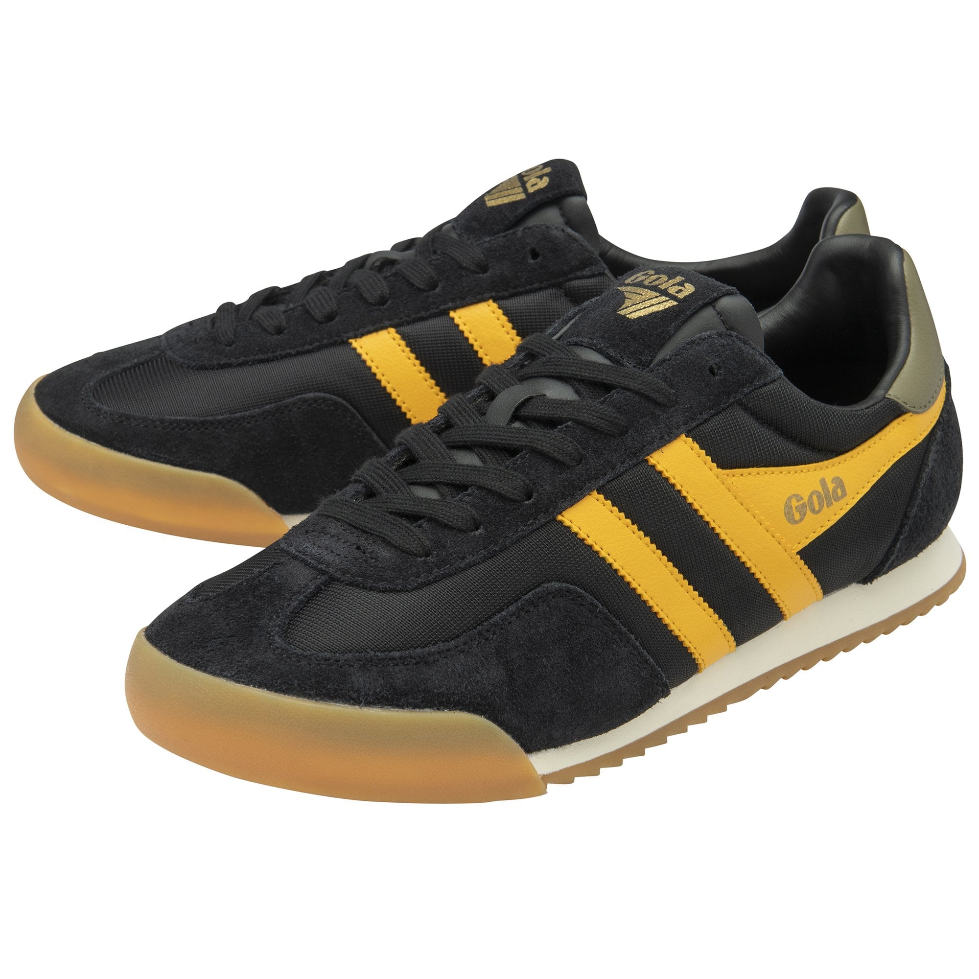 Pair of black and gold Gola sneakers with gum soles, one slightly behind the other.