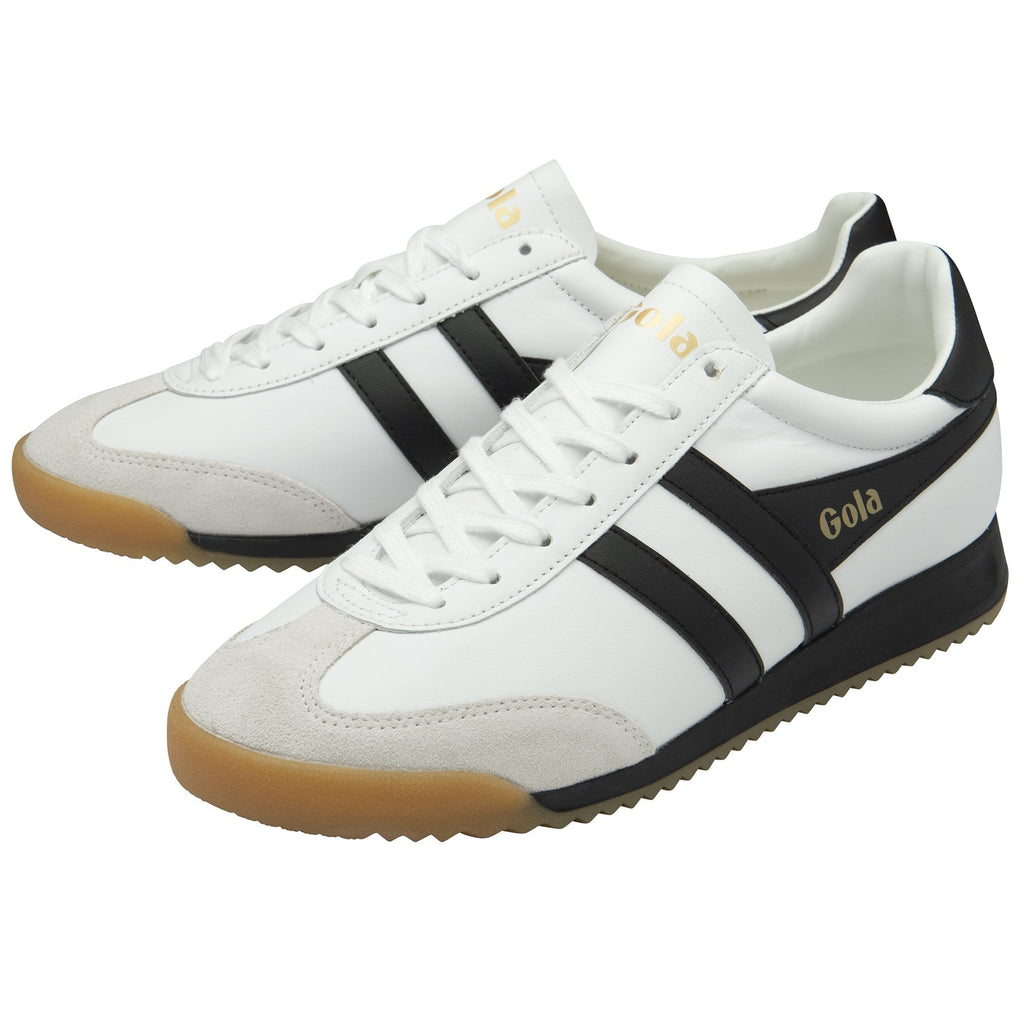 Pair of Gola Harrier trainers in white with black stripes and gum soles.