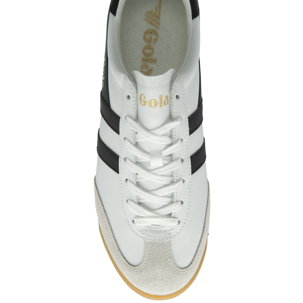 Top down view of a Gola Harrier trainer in white with black stripes and laces.