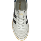 An overhead view of a single white Gola sneaker with black stripes and laces.