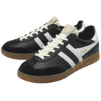 A pair of black Gola Daytona trainers with white stripes and gum soles.