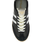 Top-down view of a black Gola Daytona trainer with white stripes and laces.