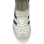Top down view of a white Gola sneaker with black stripes and a gum sole.