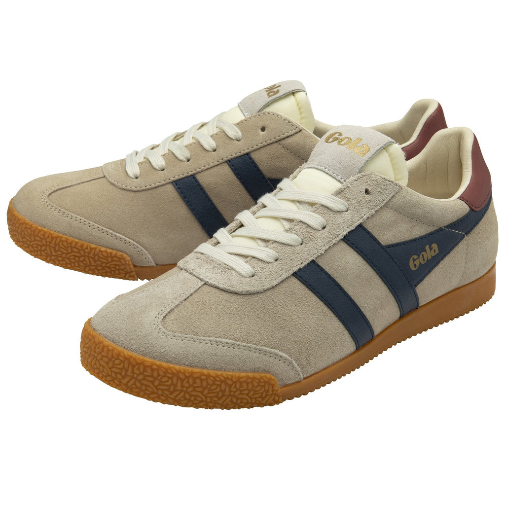 Two Gola Harrier trainers in beige with navy stripes are side by side.