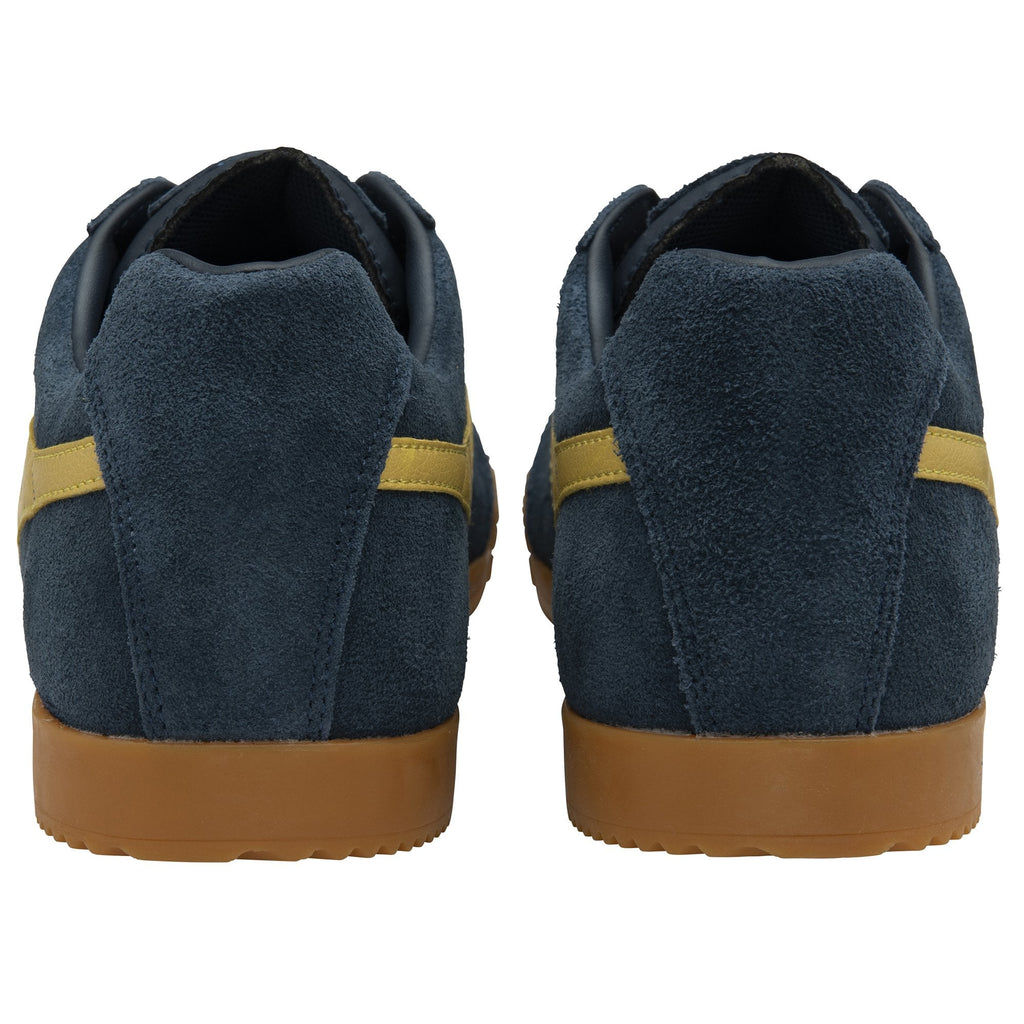 The back view of a pair of Gola men's navy suede sneakers with gold stripes.