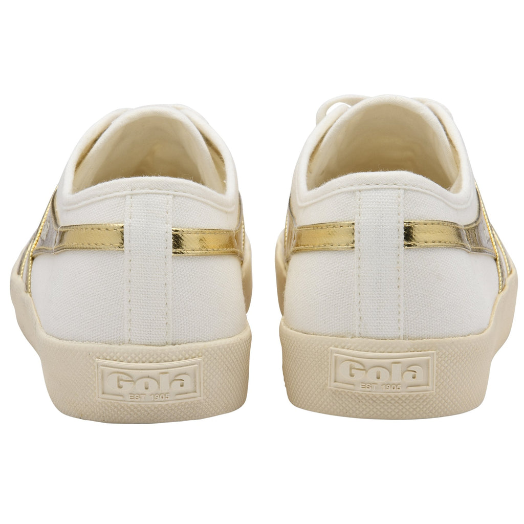 Rear view of two white and gold Gola sneakers with cream soles.