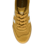 Top-down view of a mustard yellow sneaker with white stripes and laces.