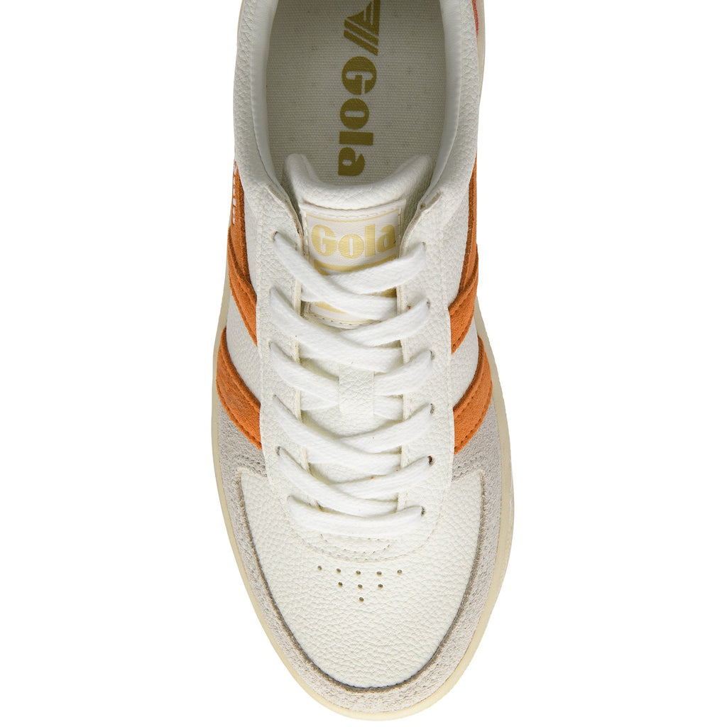 Top-down view of a white Gola sneaker with orange stripes and white laces.