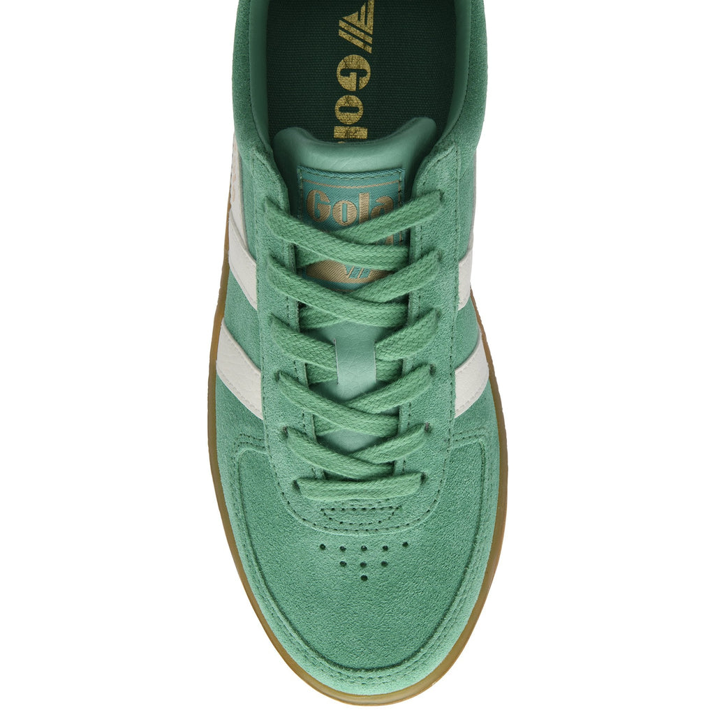 Top-down view of a green suede sneaker with white stripes and brown sole.