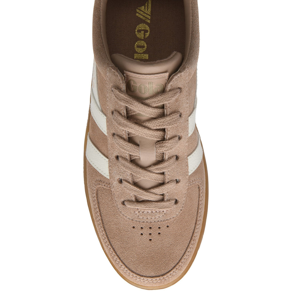 Top-down view of a tan suede sneaker with white stripes and laces.