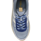 Top-down view of a light blue sneaker with white stripes and dark blue laces.