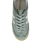 Top-down view of a light green Gola sneaker with white stripes and laces.