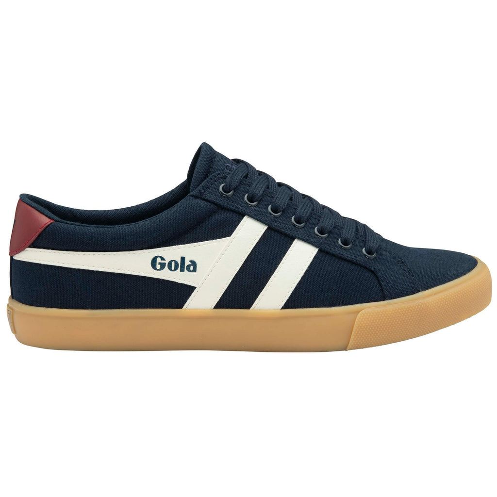 Navy blue Gola trainer with white stripes and tan sole on a white background