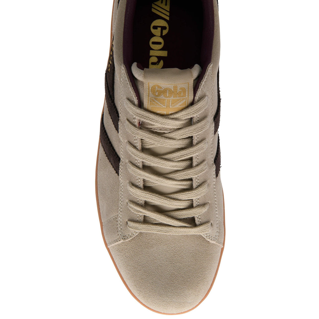Beige trainer with black accents on a white background