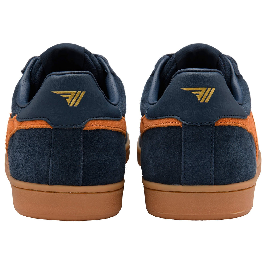 Navy blue trainers with orange accents and a brown sole on a white background