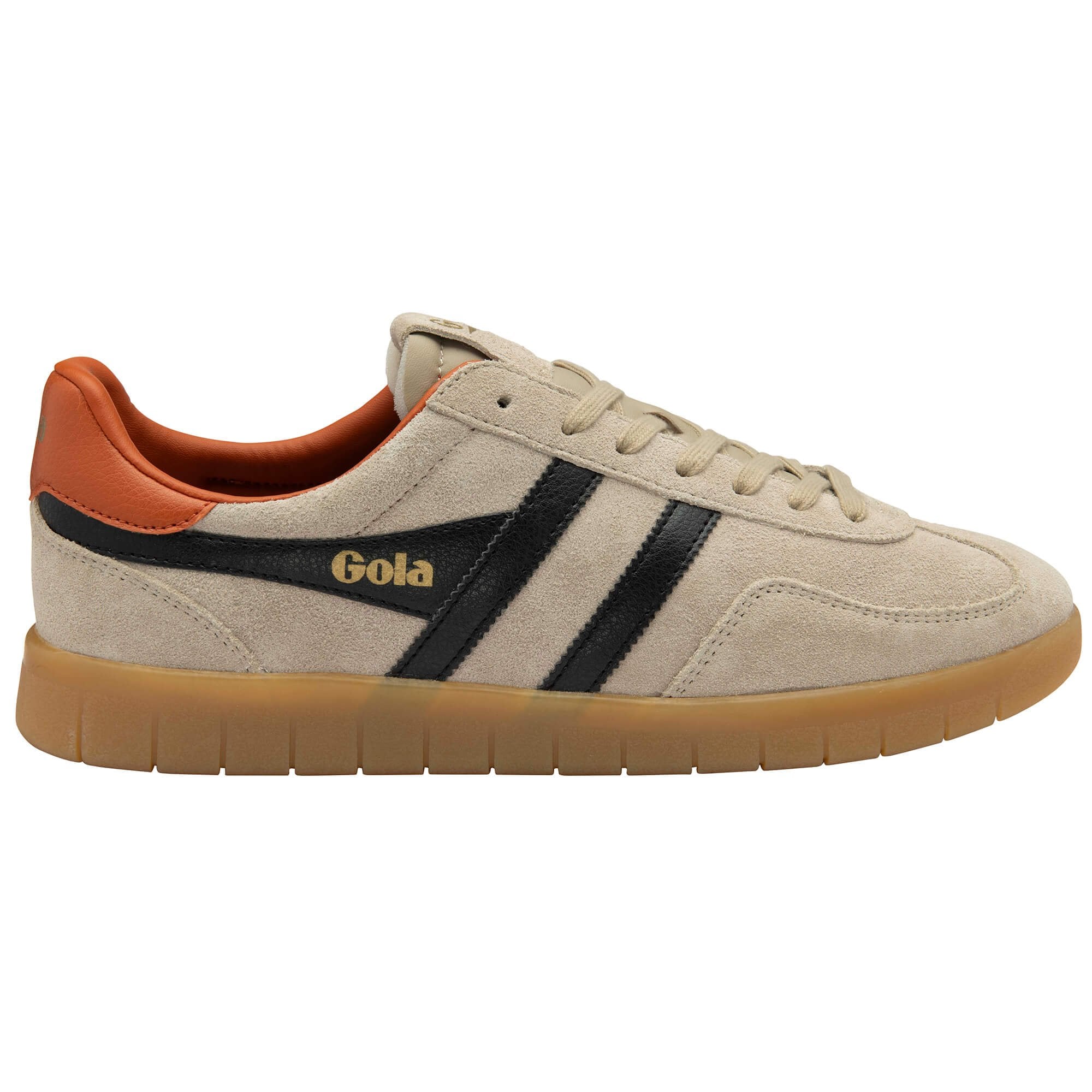 Beige trainer with orange accents and black stripes on a white background