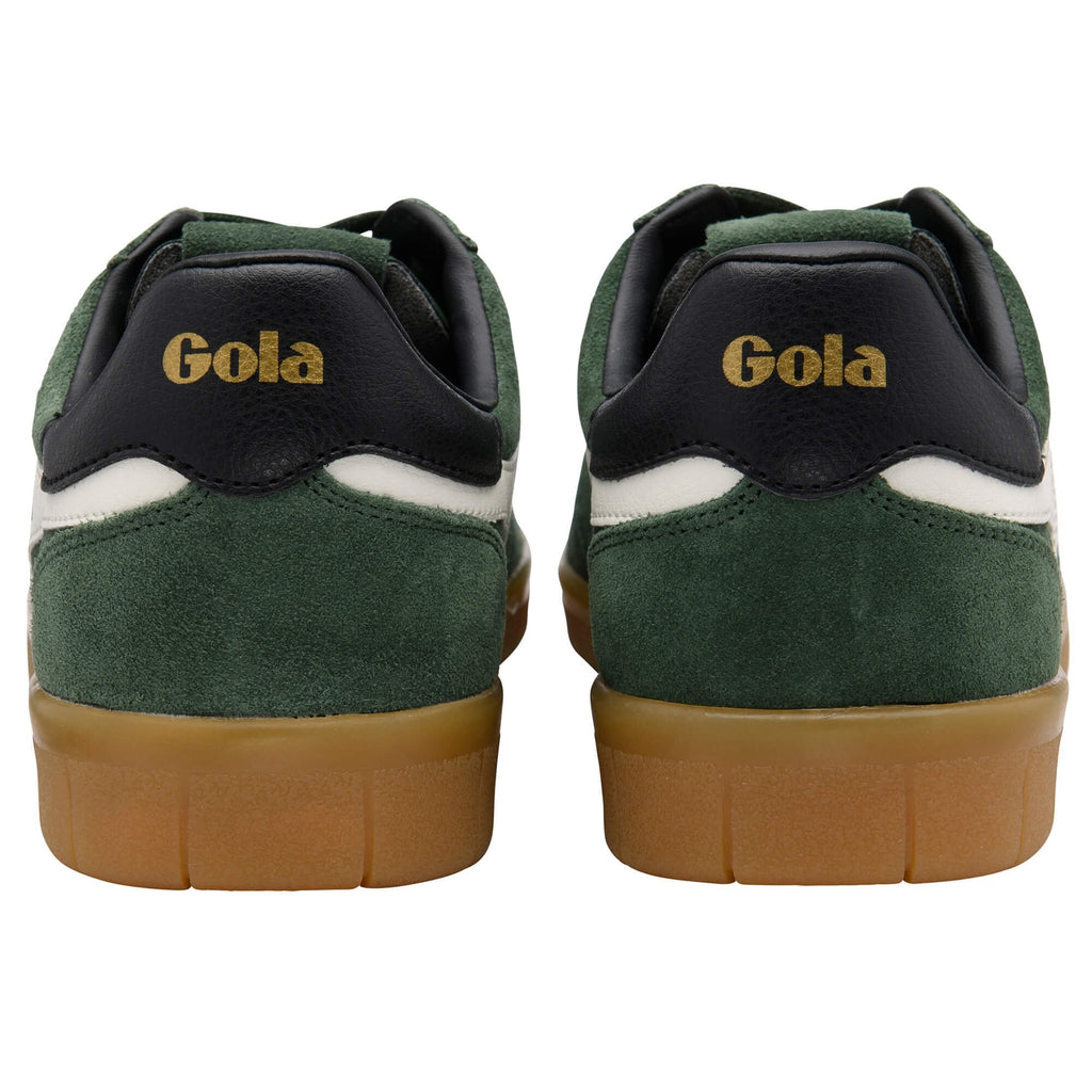 Green and black Gola trainers with brown soles on a white background