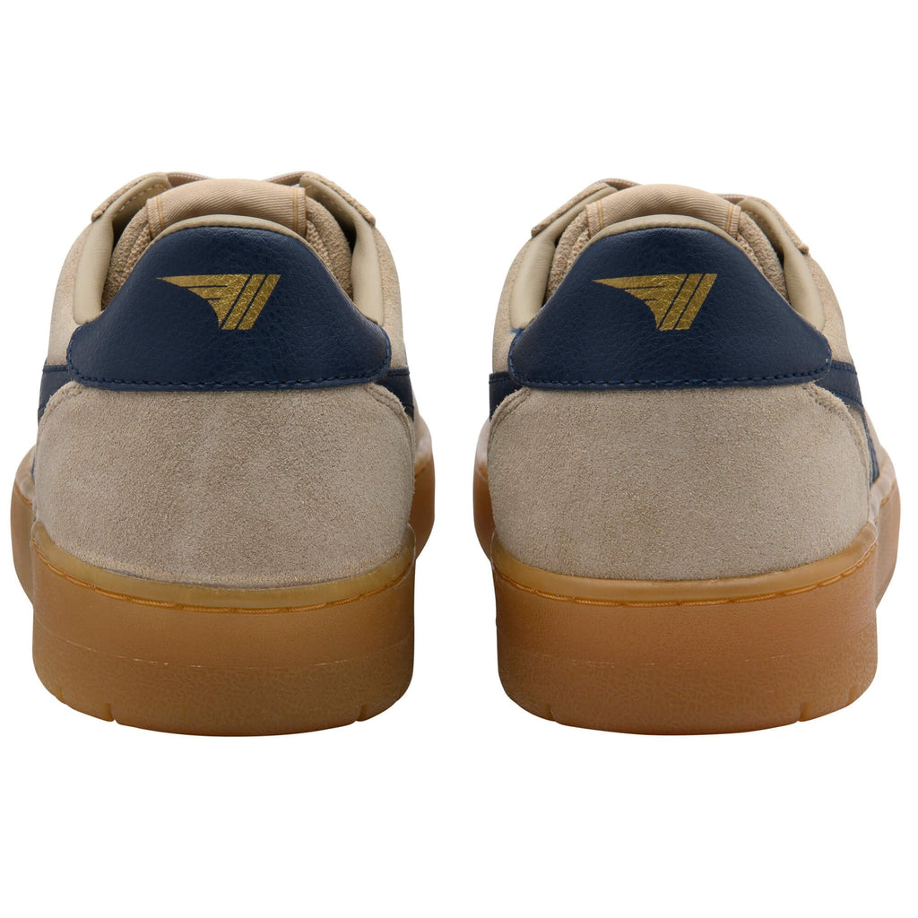 Rear view of two beige trainers with navy blue heel tabs and gold logos, brown rubber soles