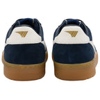 Navy and white trainers with a gold logo on a white background