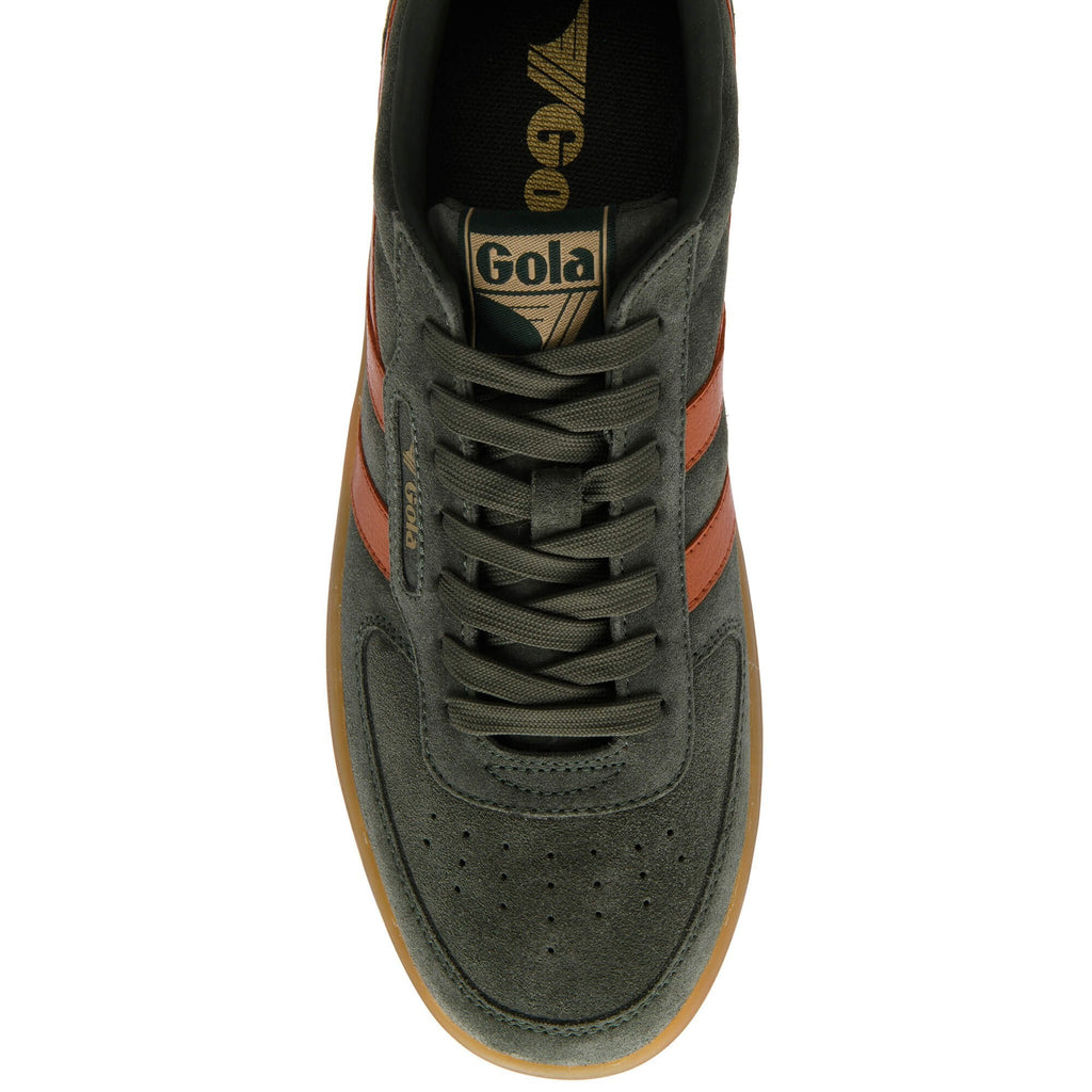 Green trainer with brown accents on a white background
