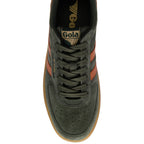 Green trainer with brown accents on a white background