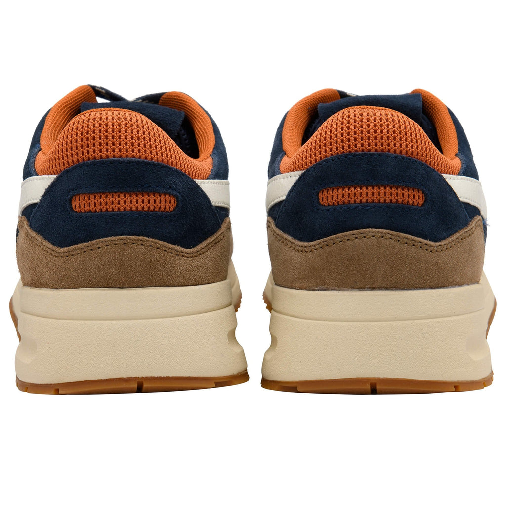 Rear view of two navy blue and brown sneakers with orange mesh accents and cream soles