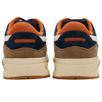 Rear view of two navy blue and brown sneakers with orange mesh accents and cream soles