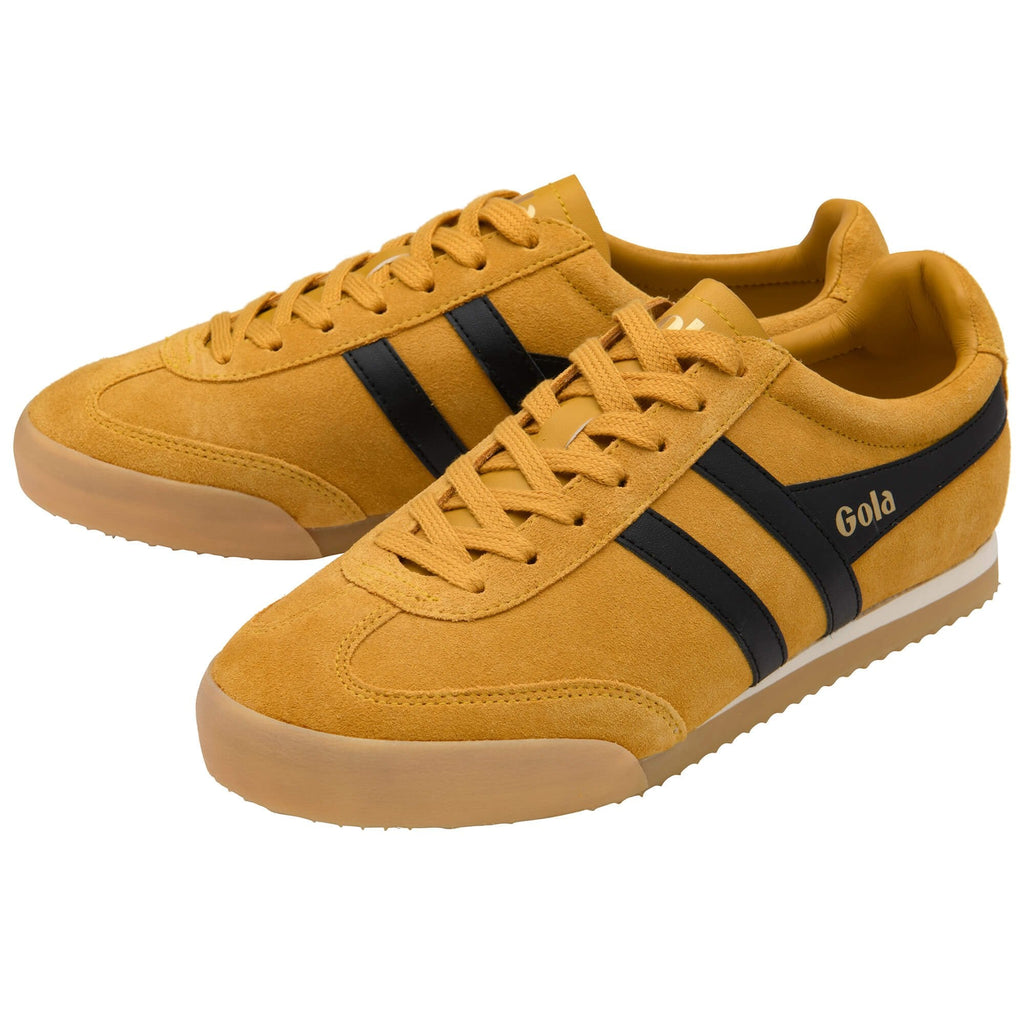 Yellow trainers with black stripes and 'Gola' branding on a white background