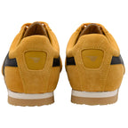 Pair of yellow trainers with Gola logo on the back on a white background